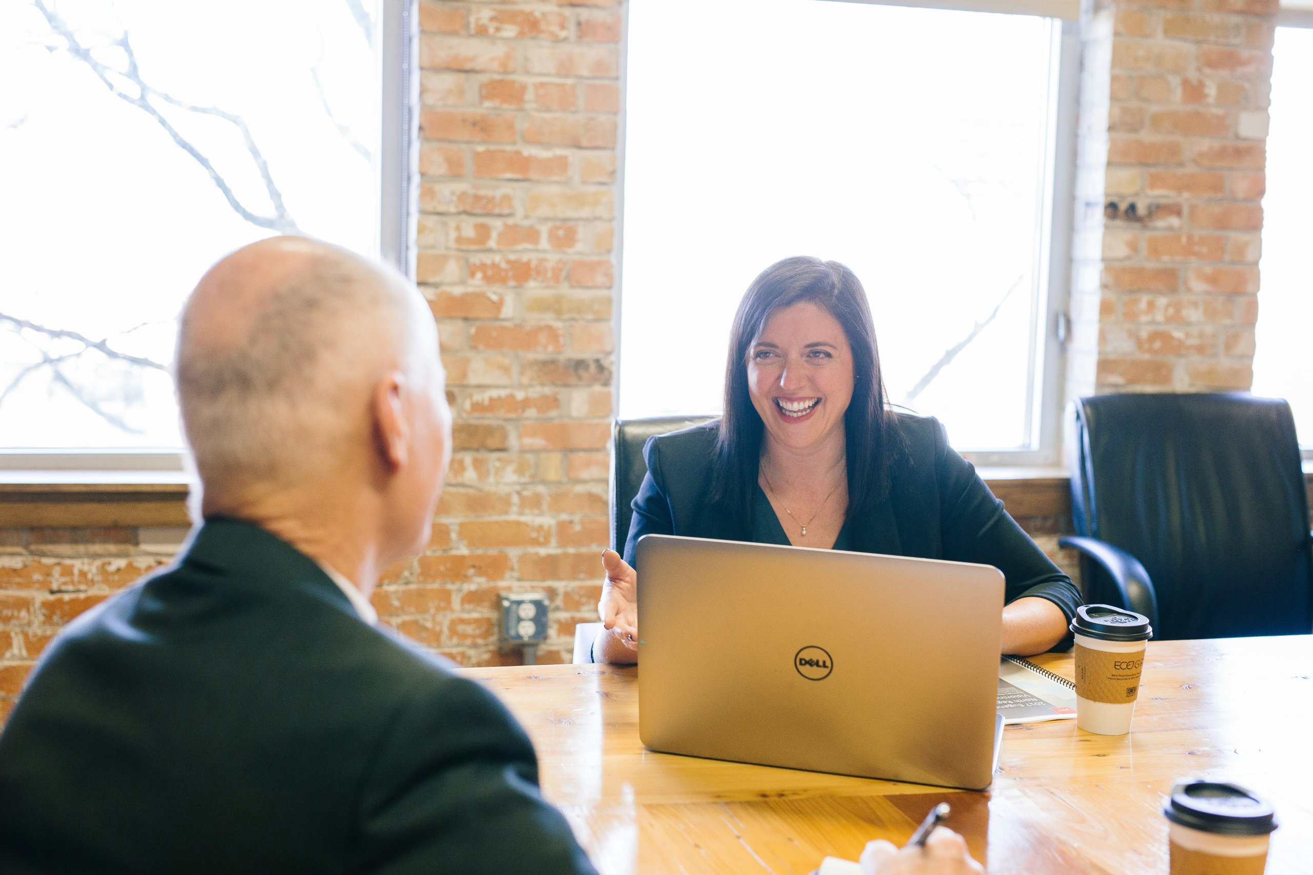 Business owner reviewing financial reports to understand EBITDA, PEBITDA, and EBITDAC before selling a business.